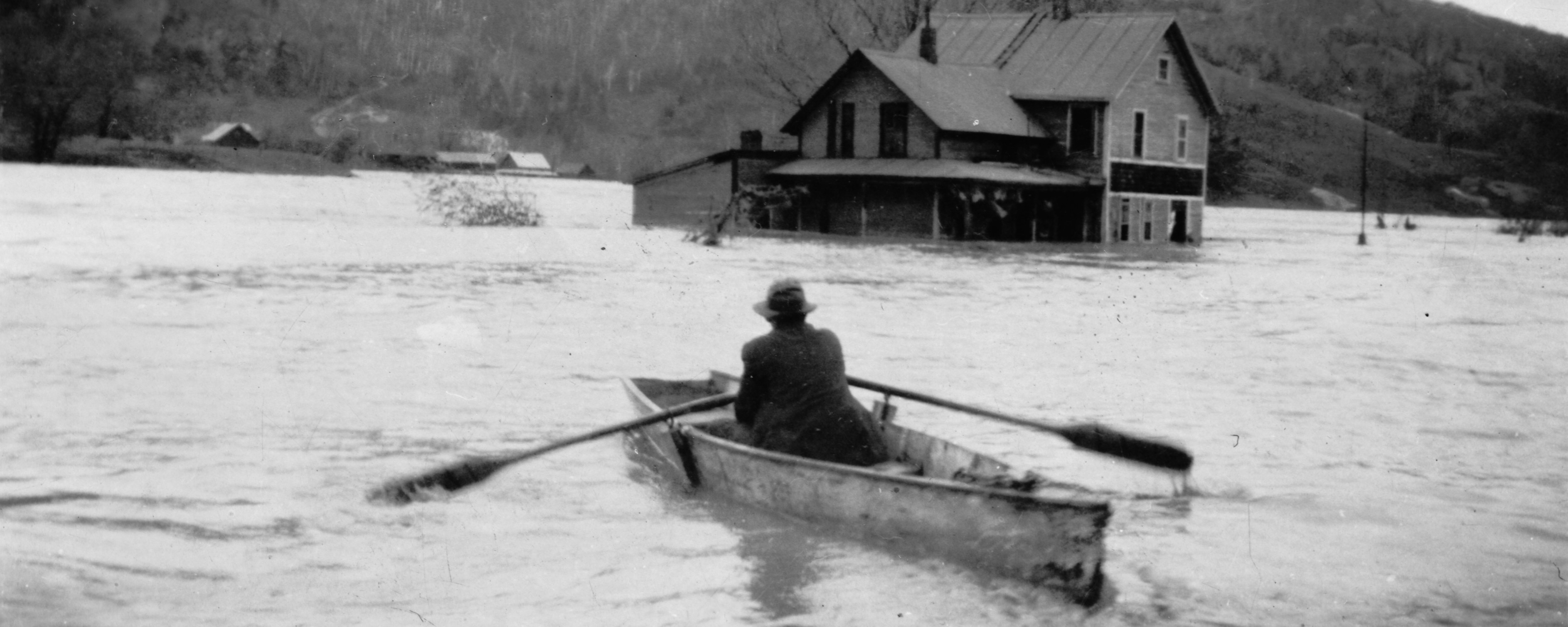 man in boat during flood