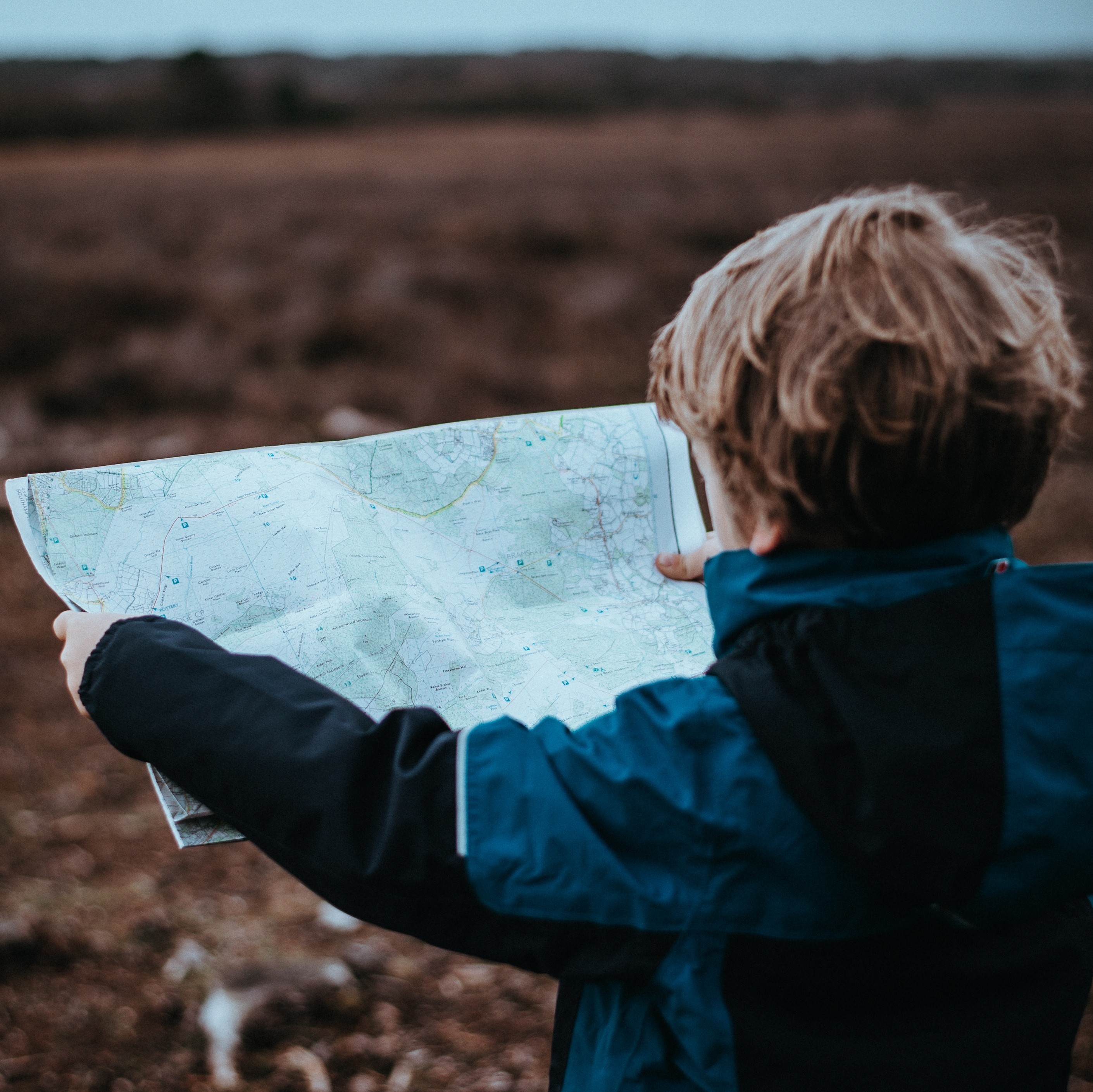 child holding a map
